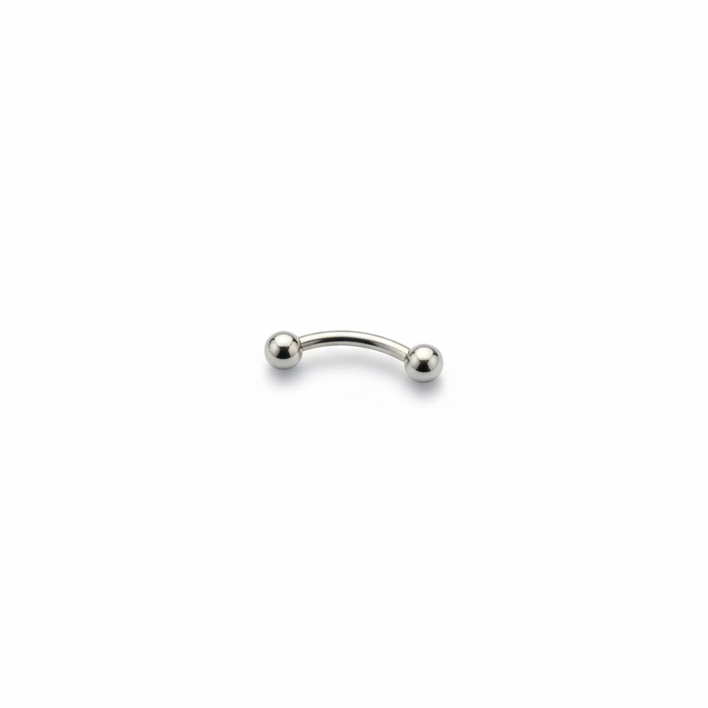 Piercing a bananina (curved barbell) in titanio di grado implantare, con palline a vite. Barra curva ipoallergenica per piercing all'ombelico, sopracciglio o rook. Disponibile in diverse lunghezze.