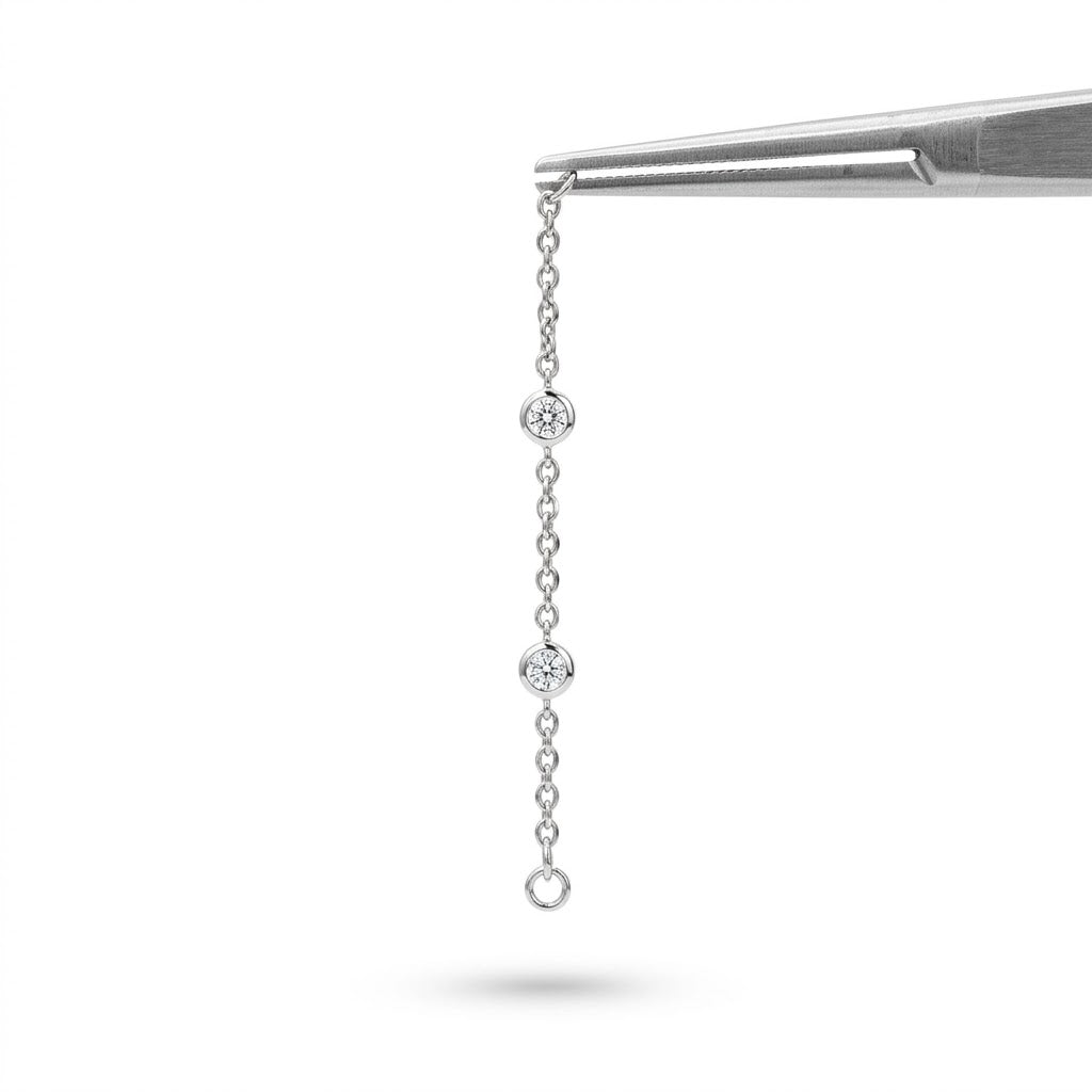 Rinnova il tuo stile con la nostra catenina pendente per piercing, l'accessorio perfetto per dare un tocco di luce e movimento unico ai tuoi piercing. Progettata per chi cerca il perfetto equilibrio tra estetica raffinata e comfort quotidiano, questa creazione unisce design e qualità professionale