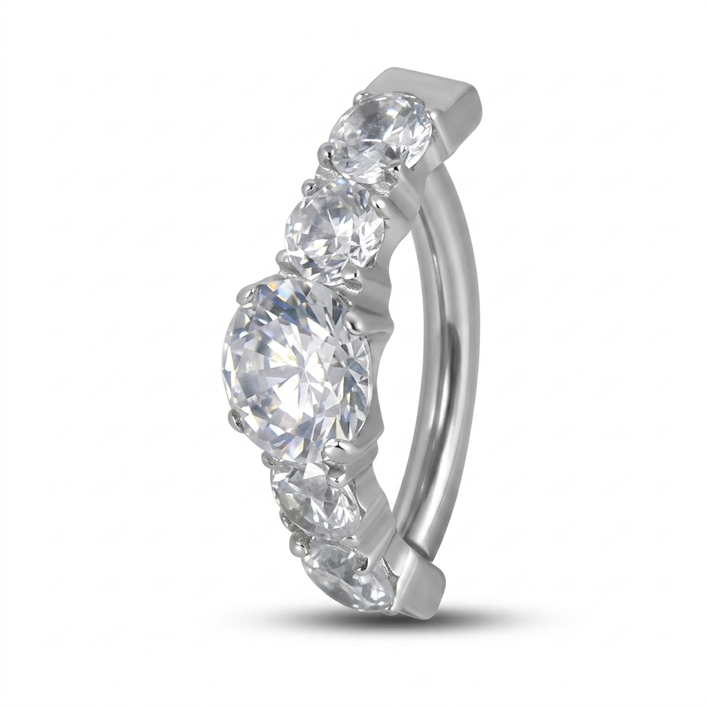 Piercing ombelico in titanio ASTM F136 con elegante fila di zirconi ovali ad alta brillantezza. Ipoallergenico, resistente e perfetto per valorizzare il tuo look con un tocco di luce.