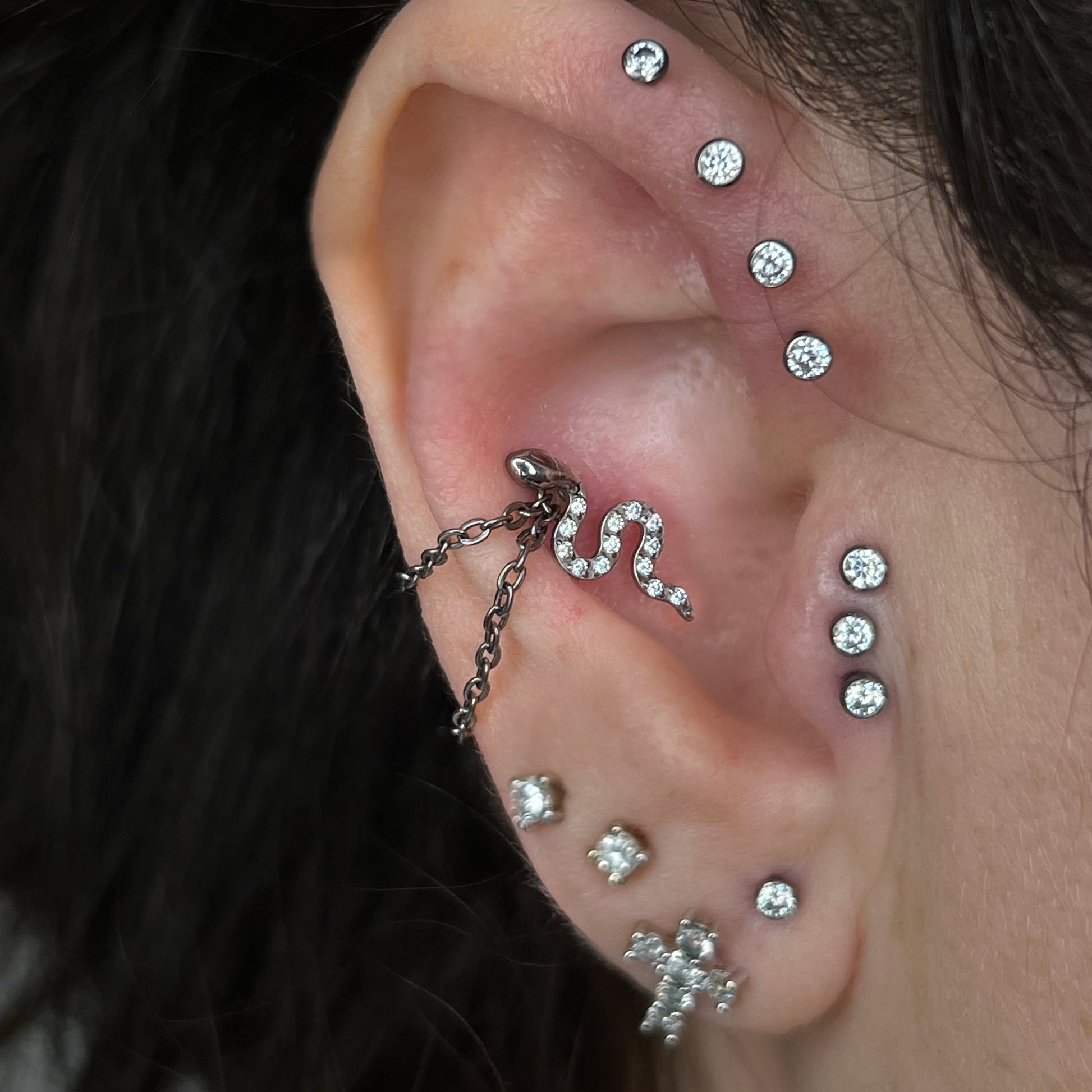 Catenella doppia "Double Chain" in titanio di grado implantare, usata come decorazione avvolgente sul piercing Conch. Simula l'effetto di un cerchietto doppio. Ipoallergenico e personalizzabile.