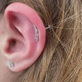 Gioiello indossato piercing Foglia (Leaf) minimalista in Titanio Chirurgico. Design elegante a forma di foglia, leggero e anallergico, eccellente per un look discreto su helix o conch.
