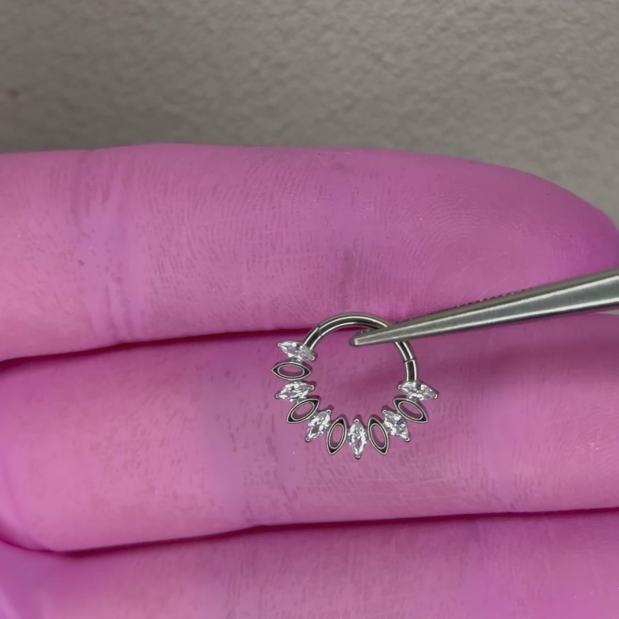 Piercing clicker elegante per septum e daith con zirconi taglio marquise e design raffinato. Realizzato in titanio, resistente, anallergico e perfetto per un look luminoso e sofisticato.