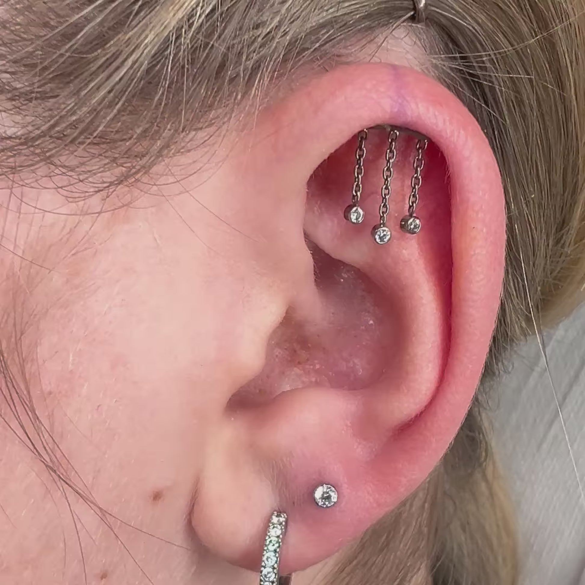 Jellyfish: piercing in titanio con catenine mobili ispirate alla medusa, elegante e sicuro per pelli sensibili.